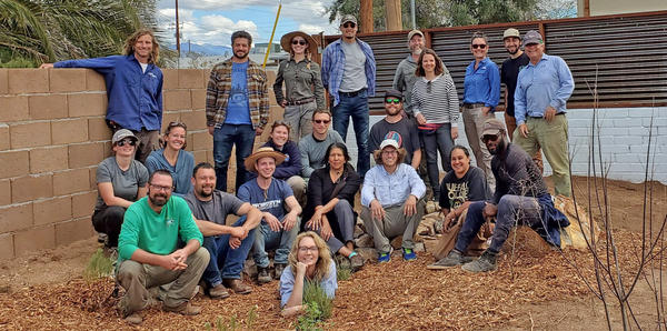 About 20 people pose