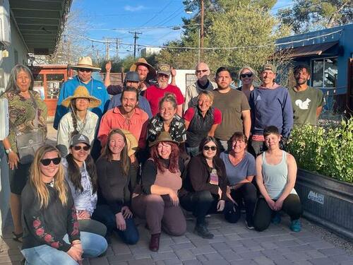 About 15 people pose for the camera