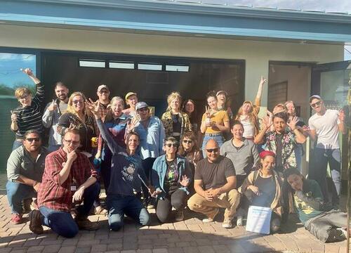 About 25 people pose for the camera