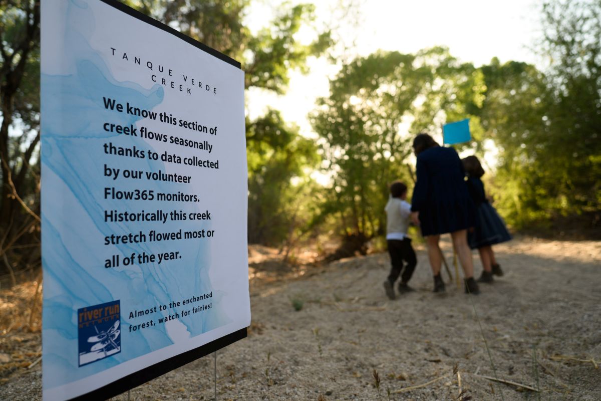 A sign in the Tanque Verde Creek thanking Flow 365 volunteers and highlighting their contributions 