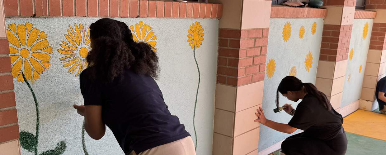 Young people paint a bright mural