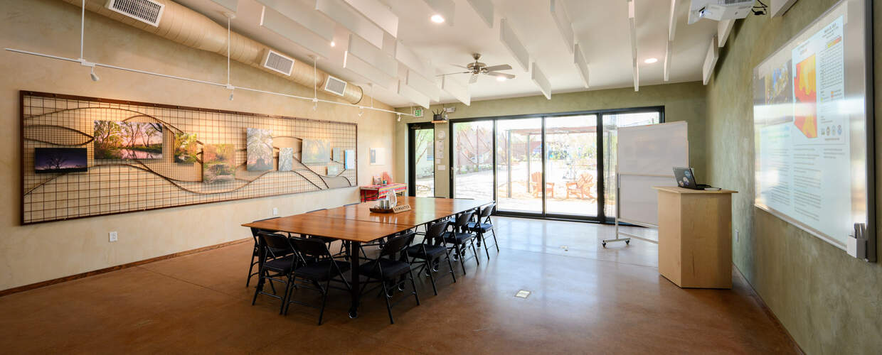 Room with tables configured in conference table setup 