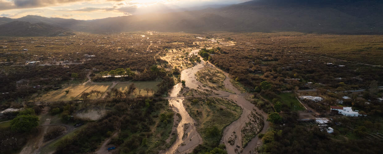 aerial view of threaded flow in a river at sunset
