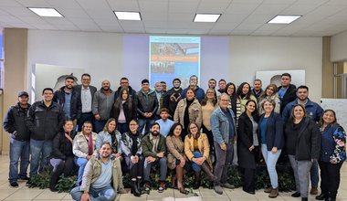 A group of several dozen people pose for the camera
